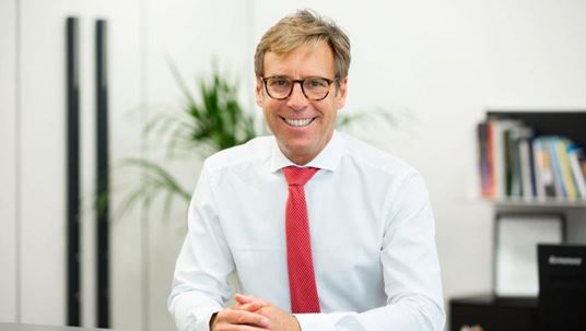 CEO of Faber-Castell Stefan Leitz wearing a white shirt with a red tie